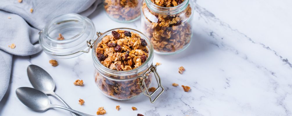 Homemade organic granola with nuts and seeds in a jar.